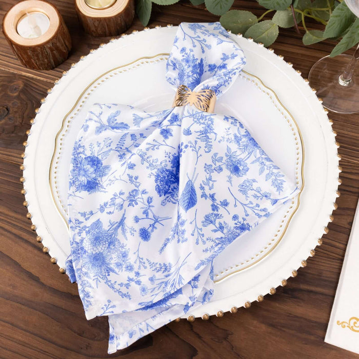 Blue floral napkin elegantly tied on a decorative plate.