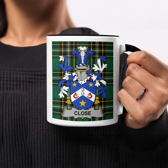 Close heritage mug featuring the family crest, black handle and tartan design.