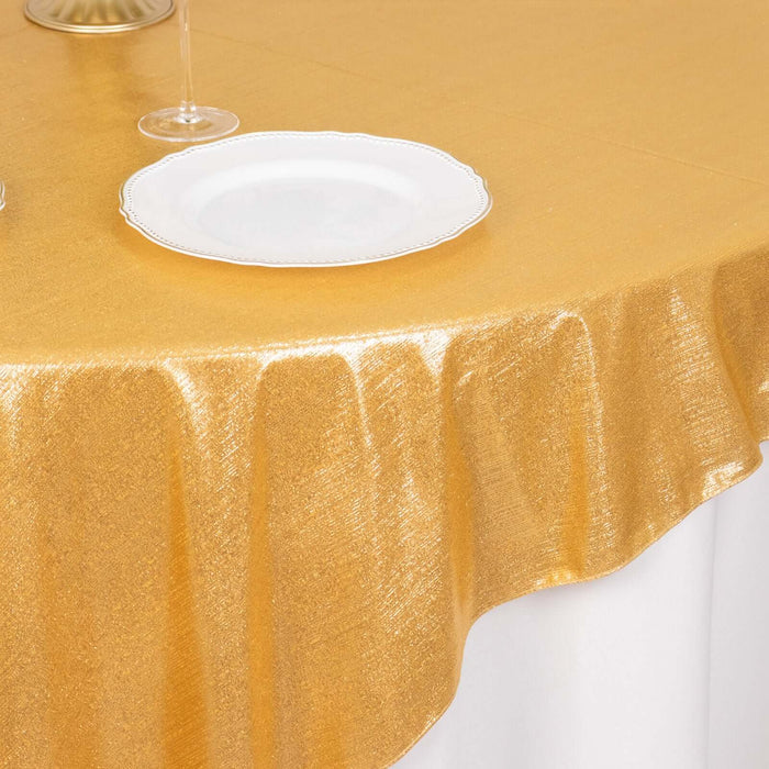 Gold tablecloth draped elegantly over a table with a white plate on top.