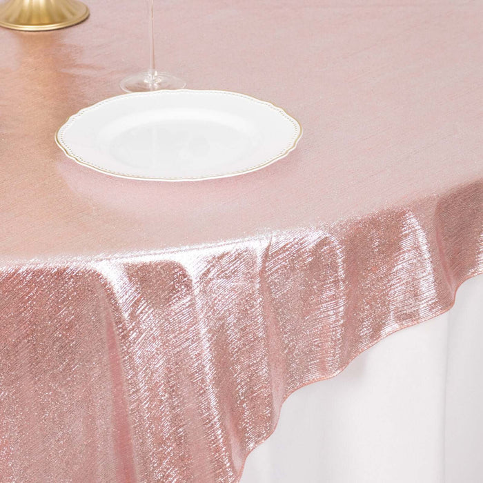 Rose gold tablecloth draping elegantly over a white table.