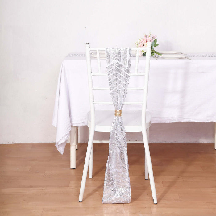 Silver sequined chair sash draped on a white chair at a table.