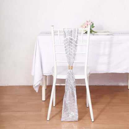 Silver sequined chair sash draped on a white chair at a table.