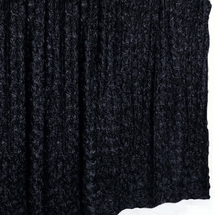 Black rose-patterned fabric draped elegantly on a white backdrop.