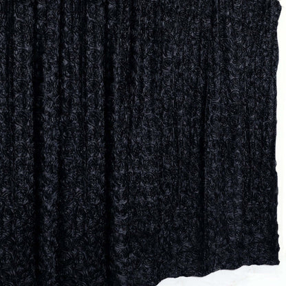 Black rose-patterned fabric draped elegantly on a white backdrop.