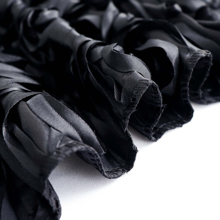 Black satin fabric with textured ruffles and smooth finish.