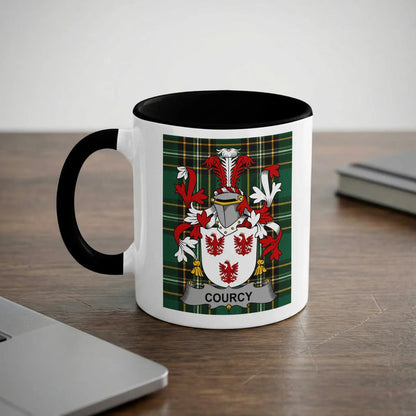 White mug with black handle and rim, featuring a Courcy family crest.