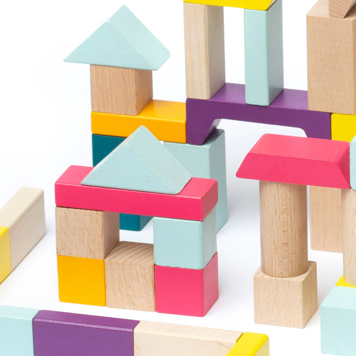 The Cubika Wooden Blocks Construction Kit by Cubika features pastel blue, yellow, pink, purple, and natural wood pieces arranged in fun structures like houses with triangular roofs—an eco-friendly and sustainable choice for creative play.