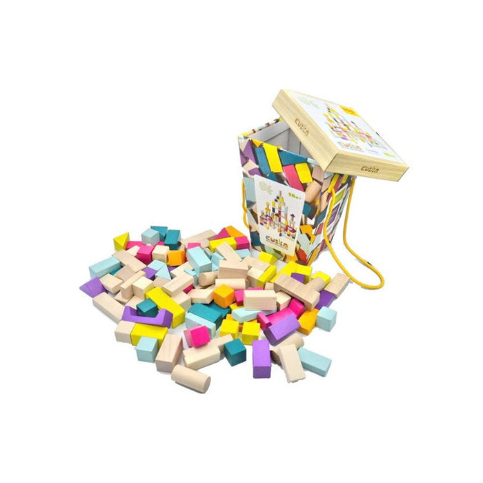 A Cubika Wooden Blocks Construction Kit bucket is tipped over, spilling eco-friendly wooden blocks in bright yellow, blue, pink, green, and natural wood. The Cubika bucket features a patterned design and a yellow carrying handle.