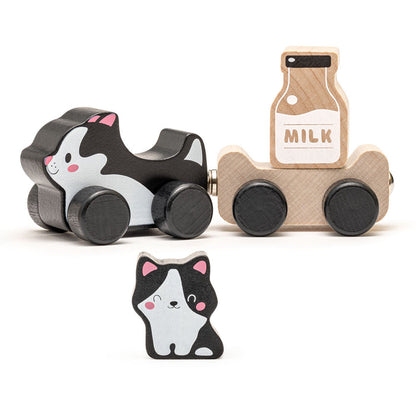 The Cubika Wooden Toy Clever Kitties by Cubika is an eco-friendly set featuring a black and white cat on wheels, a cart with a milk bottle, and a small standing cat, all in cute cartoon style.
