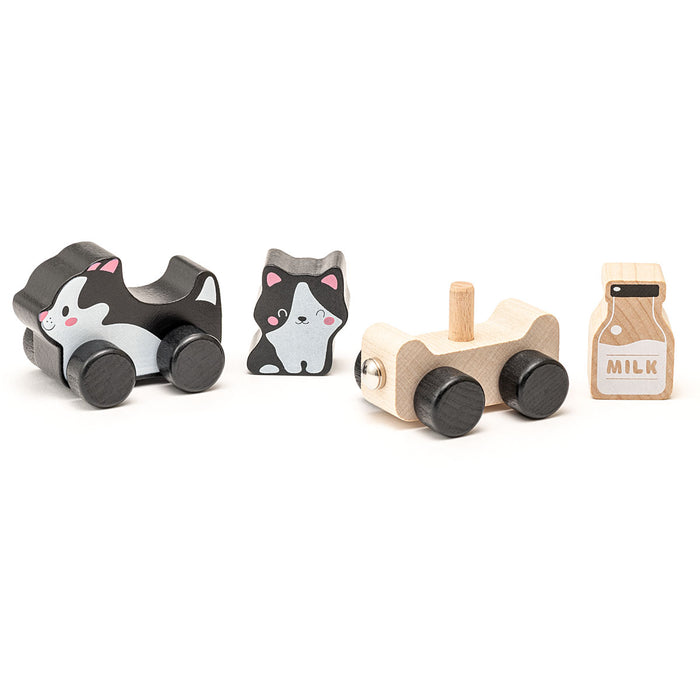 The Cubika Wooden Toy Clever Kitties by Cubika includes an eco-friendly black and white cat toy car, a small cat figure, a plain wooden wheeled base, and a milk carton block labeled "MILK.
