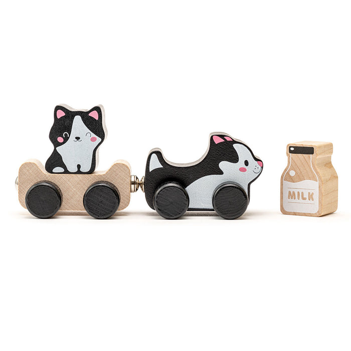 The Cubika Wooden Toy Clever Kitties by Cubika is an eco-friendly set made from organic wood, featuring a cat in a cart, a black-and-white dog pulling another cart, and a wooden milk carton with charming painted details.