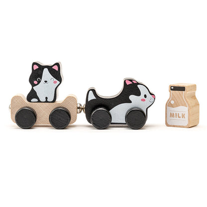 The Cubika Wooden Toy Clever Kitties by Cubika is an eco-friendly set made from organic wood, featuring a cat in a cart, a black-and-white dog pulling another cart, and a wooden milk carton with charming painted details.