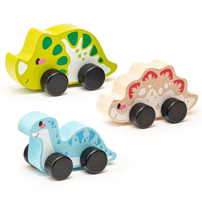 The Cubika Wooden Toy Set Joyful Dinos by Cubika includes three eco-friendly wooden dinosaurs—green with spots, beige with red accents, and light blue with blue spots—all on black wheels and smiling to the left.
