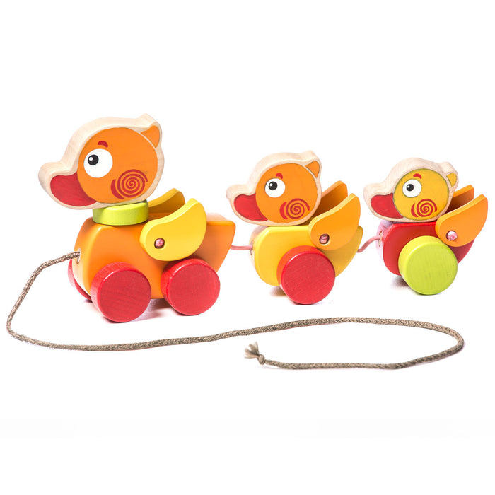 The Cubika Wooden Walk-A-Long Traveling Ducks by Cubika features a mother duck and two ducklings in vibrant colors, connected on wheels with a pull string—an ideal organic wooden toy to inspire imaginative play for toddlers.