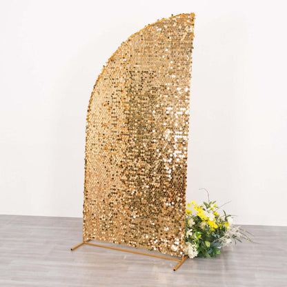 Gold sequin backdrop with floral arrangement for events or photo shoots.