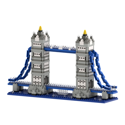 The Brixies Large Gift Box Tower Bridge is a LEGO-style micro-brick kit featuring two gray towers, blue suspension cables, and a blue base—perfect for architectural landmark fans and displayed on a white background.