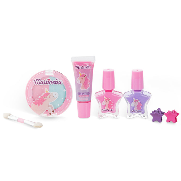 The Martinelia Little Unicorn Beauty Basics by Martinelia includes blush, lip gloss, pink and purple nail polishes, a dual-ended applicator, and two star hair clips—ideal for magical kids’ makeovers.