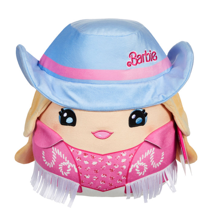 The Mattel Barbie Cutopia 10in Plush features a kawaii style with big blue eyes, blonde hair, a cheerful smile, a light blue cowboy hat with "Barbie," and a pink fringed scarf.