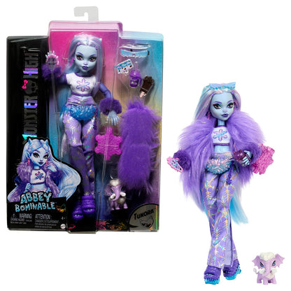 The Mattel Monster High Abbey Doll by Mattel features light blue skin, a purple furry jacket, stylish boots, signature long hair, and comes with a pet wooly mammoth. Shown packaged and posed with accessories.