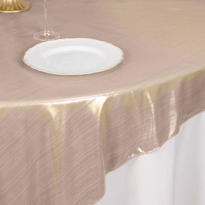 Elegant gold tablecloth draping over a table with a plate and glass