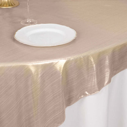 Elegant gold tablecloth draping over a table with a plate and glass