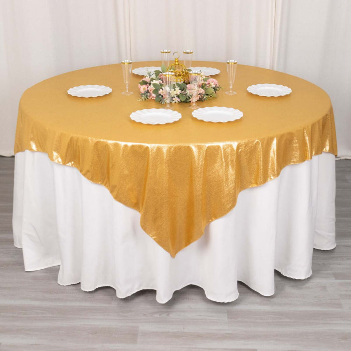 Round gold tablecloth draped elegantly over a white table.