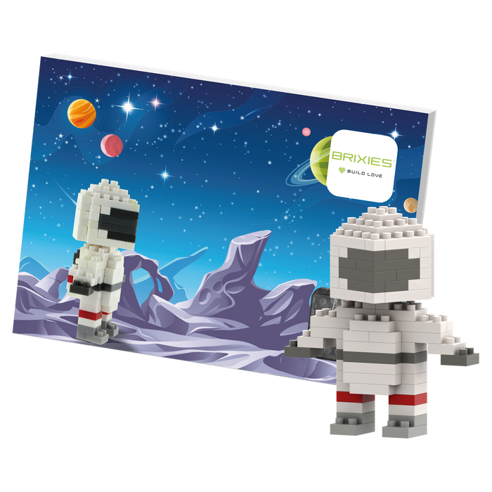 The Brixies Postcard Astronaut features a block-style astronaut figure built from micro bricks, posed before a vibrant space background with planets and stars, beside a “Brixies Build Love” sign.