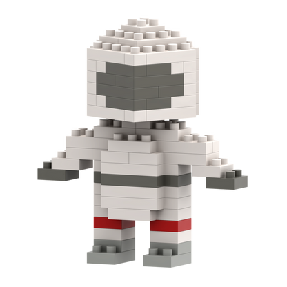 The Brixies Postcard Astronaut is a small, blocky figure made of white, gray, and red micro bricks, resembling a stylized astronaut with a square head and simple features.