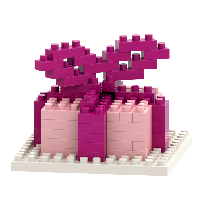 The Brixies Postcard Gift features a 3D gift box made from interlocking micro bricks in shades of pink with a large bow, displayed on a white baseplate. This unique model is part of the creative Brixies Postcard series.