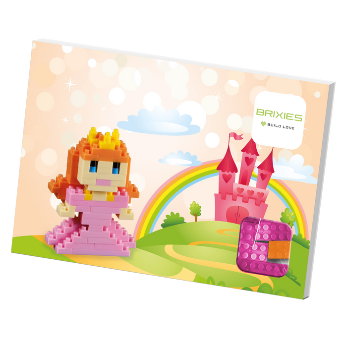 The Brixies Postcard Princess features a pixel-style 3D princess in front of a pink castle, rainbow, logo, and block heart—an ideal display for any Brixies Post Card or mini build kit.