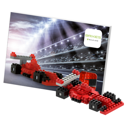 The Brixies Postcard Racing Car is a micro brick model in red and black, showcased with a racing-themed backdrop, track lights, and Brixies logo—a perfect mini build kit for fans of race car postcards.