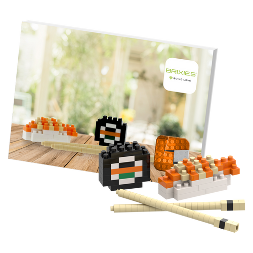 The Brixies Postcard Sushi is a small, colorful 3D sushi model built from blocks, displayed with chopsticks and a Brixies logo card—perfect as a mini build kit or unique mailable postcard gift.