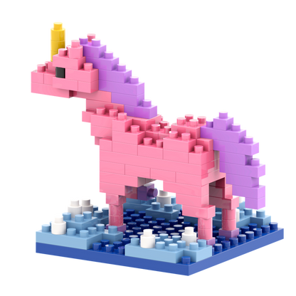 The Brixies Postcard Unicorn is a charming mini build kit featuring colorful micro bricks—mainly pink with a yellow horn, purple mane and tail—standing on a blue base with white and blue accents, perfect for unicorn lovers.