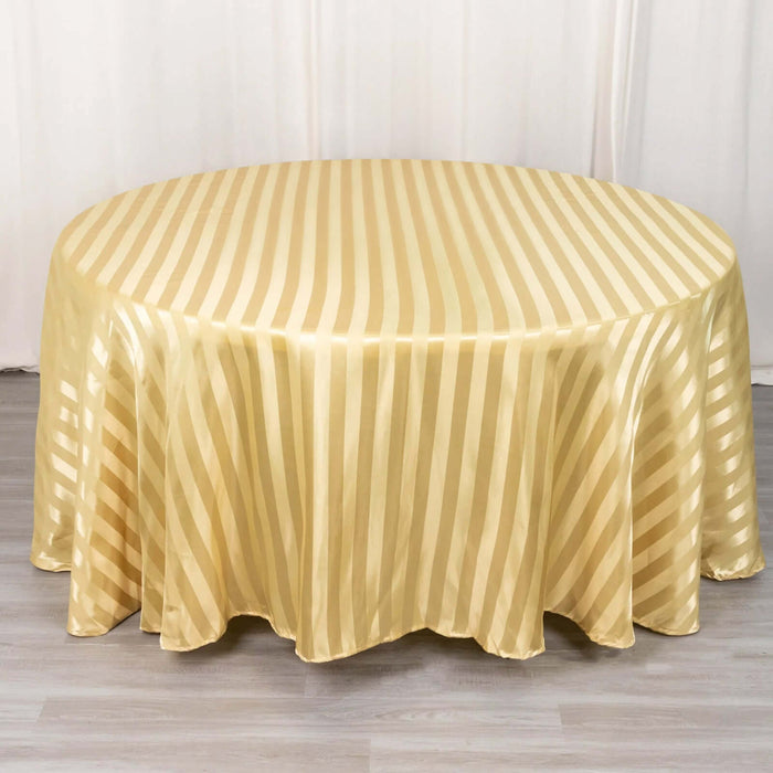 Gold striped round tablecloth on a light wooden surface.
