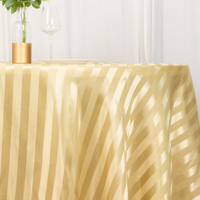 Gold striped tablecloth draped elegantly on a table with decor.