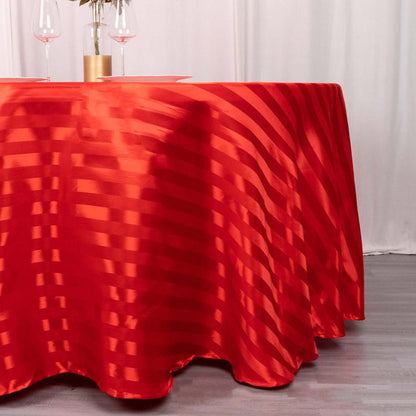 Red striped tablecloth draping elegantly over a round table.