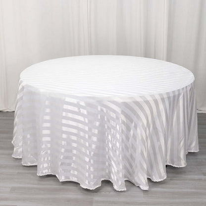 Round white tablecloth with subtle striped pattern on a plain background.