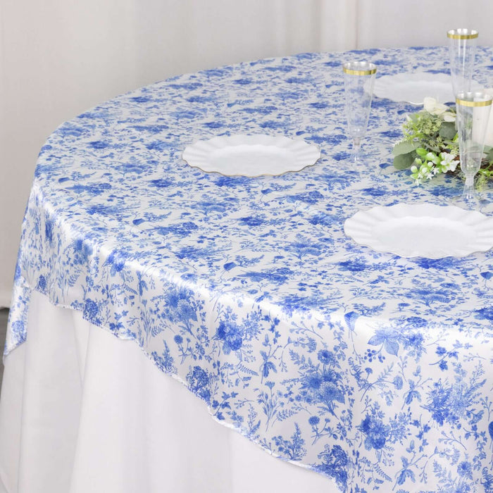 Blue floral tablecloth on a round table, enhancing elegant dining decor.