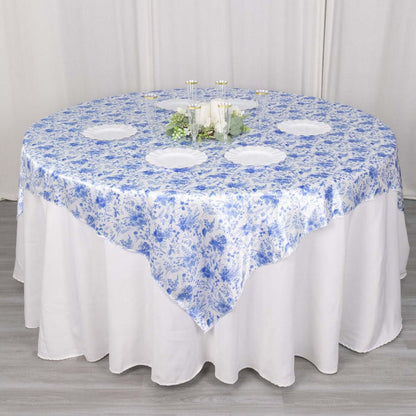 Round table covered with a blue floral tablecloth.