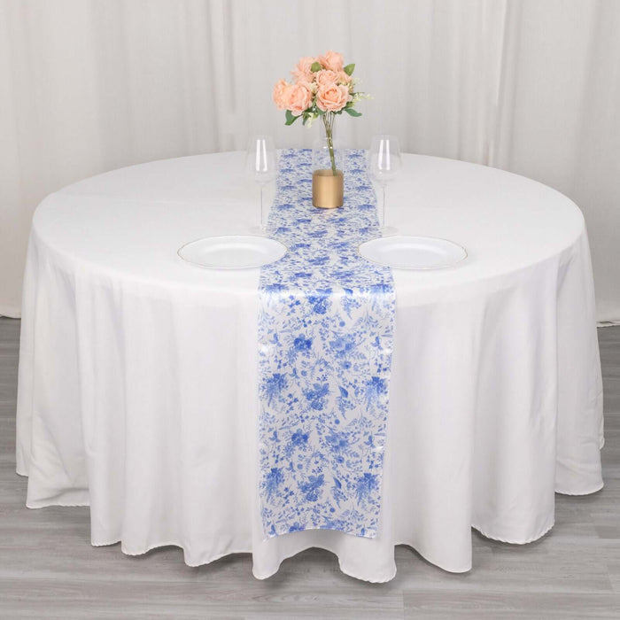 Round table set with a floral runner and vase of roses.