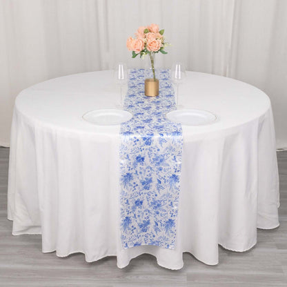 Round table set with a floral runner and vase of roses.