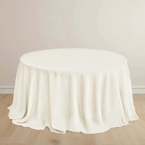 Round table with a soft, white tablecloth draping elegantly.