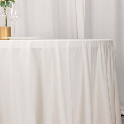 White tablecloth draping elegantly over a table in a minimalist setting.