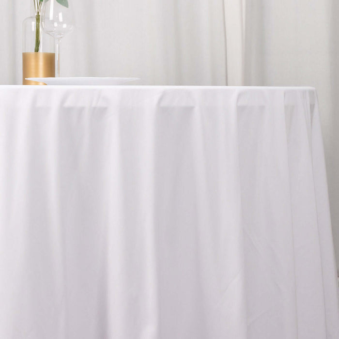 Elegant white tablecloth draping over a table with minimalistic decor.