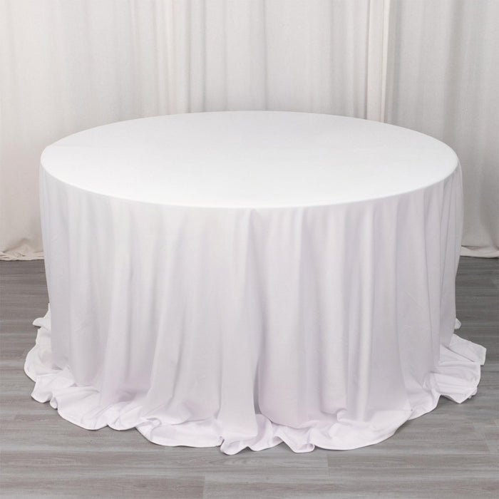White round table with a draped tablecloth