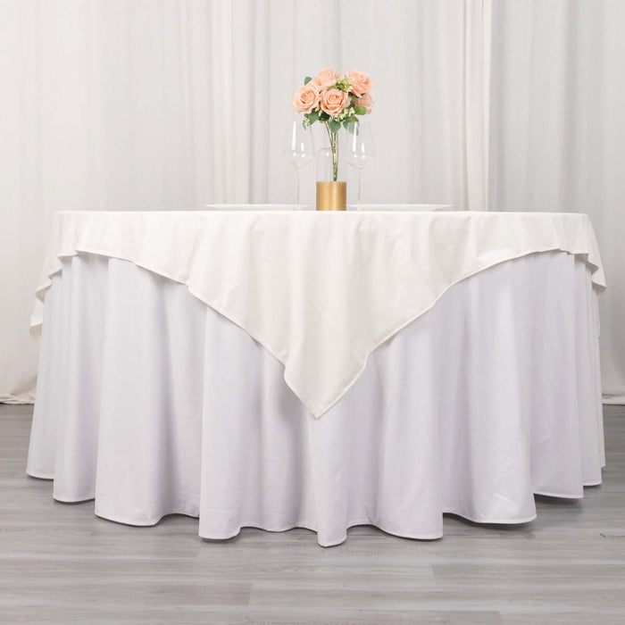 Elegant round table with white tablecloth and floral centerpiece.