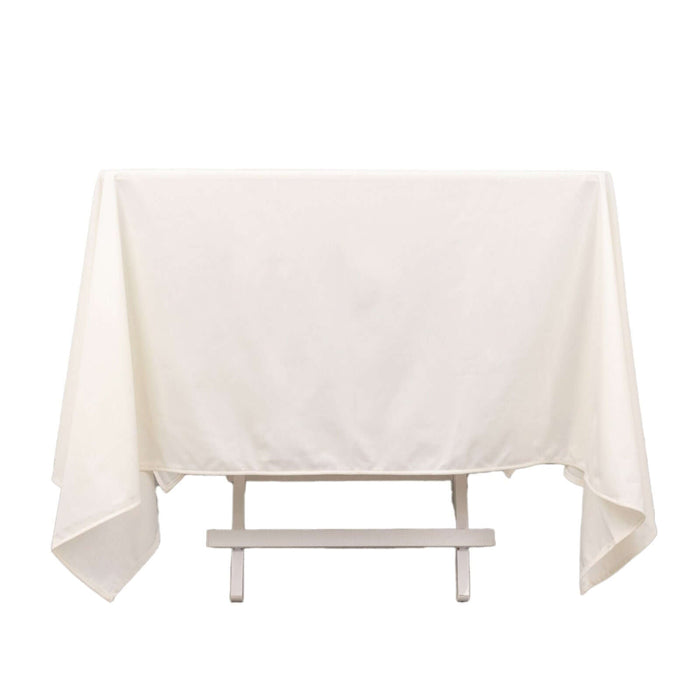 White tablecloth draped over a table in a studio-style shot.