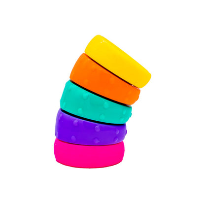 The Sensory Lab Twisty Stack by Sensory Lab features five colorful, textured rings in yellow, orange, teal, purple, and pink stacked in a leaning tower—an engaging sensory toy that inspires movement, focus, and creative play.