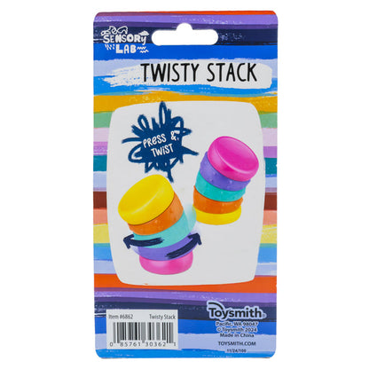 A vibrant Sensory Lab Twisty Stack package displays two stacked, multicolored sensory toys with "Press & Twist" instructions on a rainbow-striped background, highlighting motion play and Sensory Lab branding.