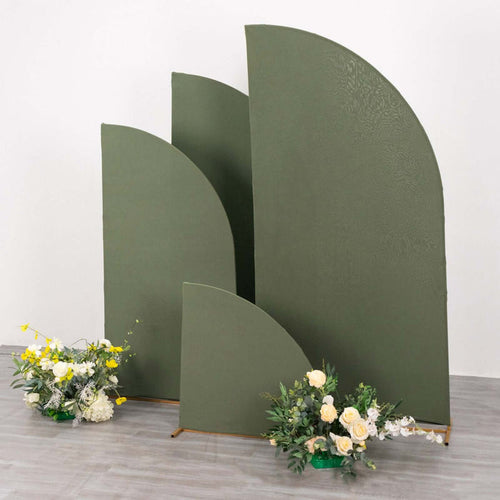 Green curved backdrops with floral arrangements in a studio setting.